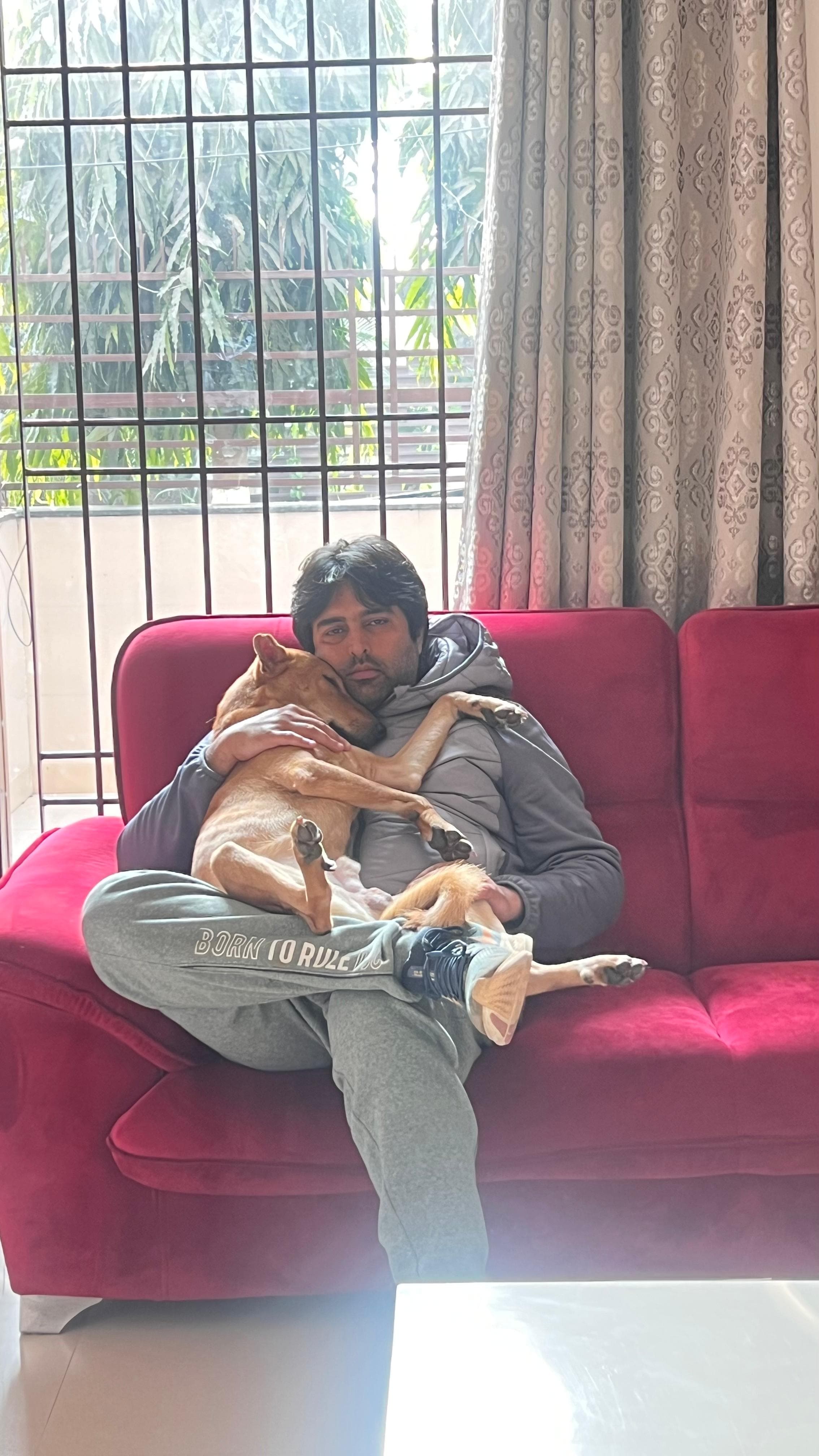 Rickey Dharmani, Managing Partner of The Bhau Project, with a rescued dog